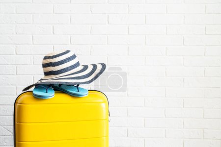 Photo for Suitcase, hat, passports and flip flops on white background. Happy Holidays, travel concept. - Royalty Free Image