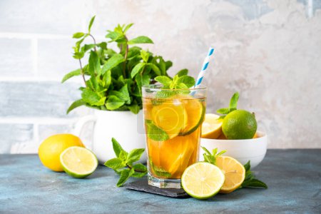 Photo for Iced tea. Summer drink with lemon, lime, mint and ice. Cold lemonade. - Royalty Free Image