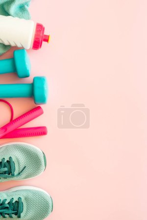 Photo for Fitness equipment on pink background. dumbbells, towel and bottle of water. Training, workout and fitness concept. - Royalty Free Image