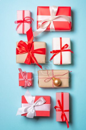 Photo for Christmas presents on blue background. Boxing day concept with holiday decorations. Top view with copy space. - Royalty Free Image