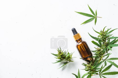 Photo for CBD oil and cannabis leaves at white table. Medicine and cosmetic product. Flat lay image. - Royalty Free Image