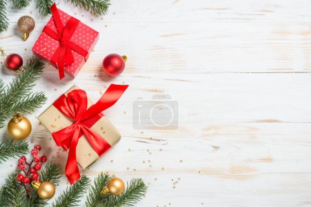 Photo for Christmas present box with red ribbon and holiday decorations. Top view at white wooden table. - Royalty Free Image