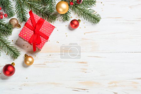 Photo for Christmas background at white. Christmas present box with red ribbon and holiday decorations. Flat lay image with copy space. - Royalty Free Image