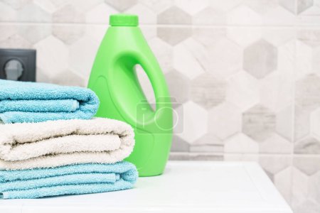 Photo for Stack of bath towels and detergent. Clean towels in the laundry or bathroom. - Royalty Free Image