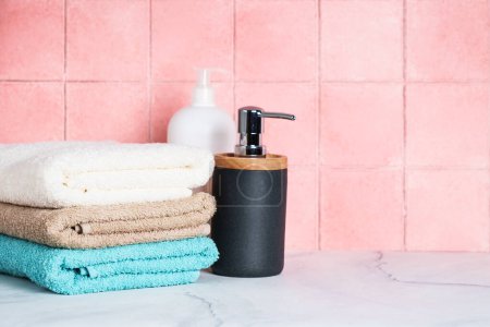 Photo for Clean towels and cosmetic products in the bathroom. - Royalty Free Image