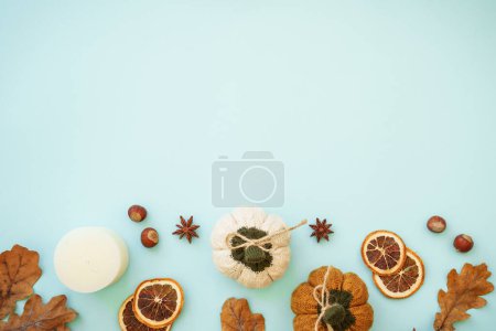 Photo for Autumn home decor background on blue. Dry leaves, spices and decorations. Flat lay image with copy space.. - Royalty Free Image