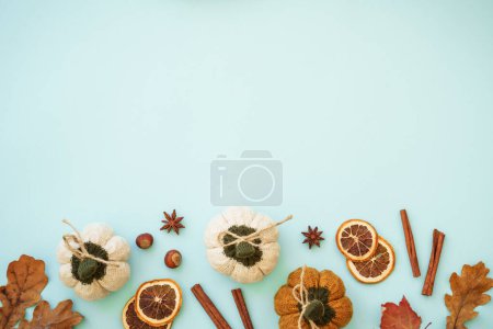 Photo for Autumn home decorations on blue background. Dry leaves, spices and decorations. Flat lay image with copy space.. - Royalty Free Image