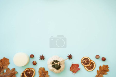 Photo for Autumn background on blue. Dry leaves, spices and decorations. Flat lay image with copy space.. - Royalty Free Image