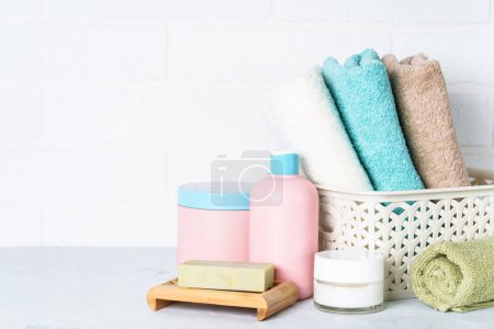 Téléchargez les photos : Produits cosmétiques et serviettes propres dans la salle de bain. Soins spa et beauté. - en image libre de droit