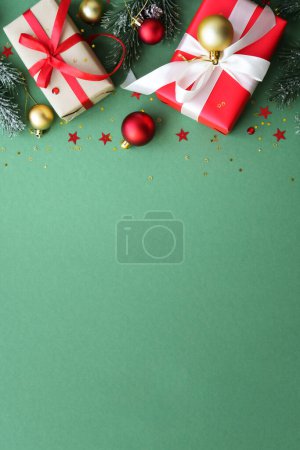 Photo for Christmas Present and red decorations at color background. Flat lay image with copy space. - Royalty Free Image