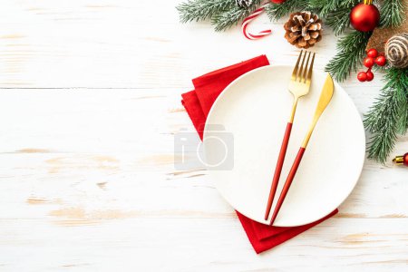 Photo for Christmas table with holiday food background. White plate and decorations top view. - Royalty Free Image