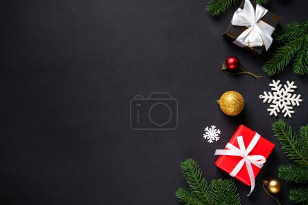 Photo for Black christmas flat lay background. Christmas fir tree with presents and holidays decorations. - Royalty Free Image