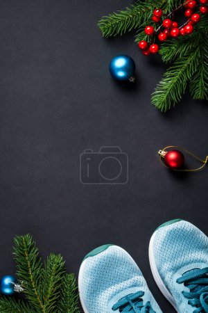 Photo for Chhristmas fitness and healthy lifestyle concept. Christmas holiday decorations and sport equipment at black background. Flat lay with copy space. - Royalty Free Image