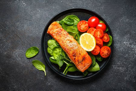 Photo for Grilled salmon fillet with fresh salad. Healthy food, Keto diet, low carb. Flat lay at black. - Royalty Free Image