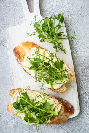 Photo for Toast with cream cheese and micro greens. Healthy food, vegetarian, natural vitamins. Top view. - Royalty Free Image
