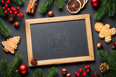Photo for Christmas food and ingredients for cooking at black. Gingerbread cookies, cinnamon, anise and others with Christmas decorations. Flat lay. - Royalty Free Image