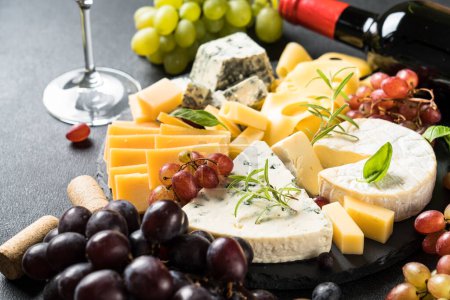 Photo for Cheese platter with craft cheese assortment on slate board. - Royalty Free Image