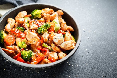 Photo for Stir fry chicken and vegetables and sesame in the wok. Asian cuisine. Close up. - Royalty Free Image