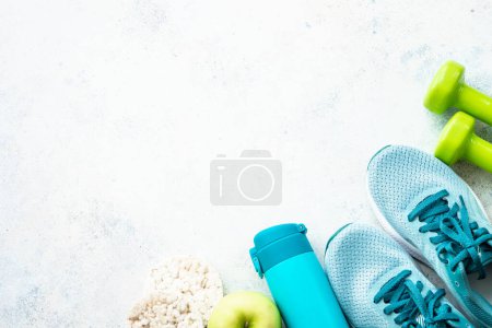 Photo for Fitness equipment, flat lay image. Sneakers, dumbbells, towel and green apple. Training, workout and fitness concept. - Royalty Free Image