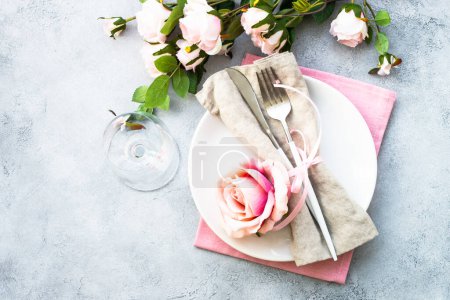 Photo for Spring Table setting with white plate and rose flowers. Table decor for an anniversary or wedding. - Royalty Free Image