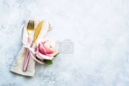 Photo for Cutlery and rose flowers. Flat lay at white background with copy space. - Royalty Free Image