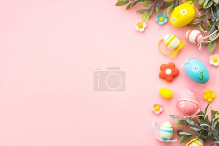 Photo for Easter background. Eggs, spring leaves and flowers on pink. Flat lay with copy space. - Royalty Free Image