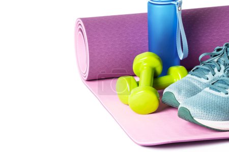 Photo for Sport equipment on white background. Yoga mat, sneakers, dumbbells and bottle of water. Healthy lyfestyle, fitness and diet. - Royalty Free Image