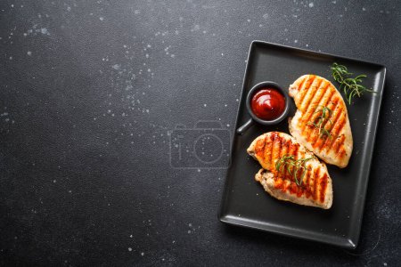 Photo for Grilled meat. Chicken steak on black background. Top view with copy space. - Royalty Free Image