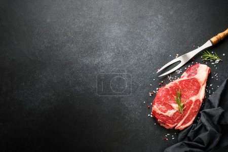 Photo for Raw meat steak with spices on black background. Beef steak ribeye. Top view with copy space. - Royalty Free Image