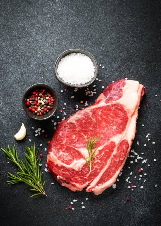 Photo for Meat steak. Beef steak dry aged with spices on black background. Top view. - Royalty Free Image