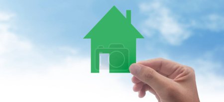 Photo for Hands holding paper house, family home and protecting insurance concept - Royalty Free Image