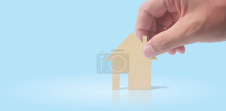 Photo for Hands holding paper house, family home - Royalty Free Image