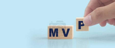 Photo for Wooden cube in hand with the letter from the mvp word . wooden cubes standing - Royalty Free Image