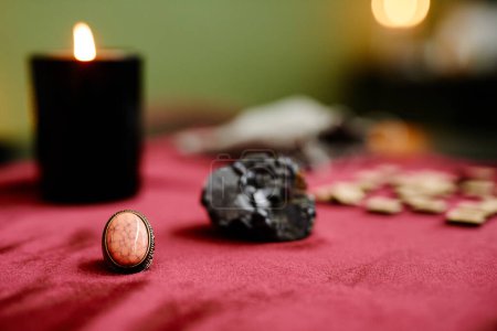 Photo for Close up of crystals and spiritual stones on red velvet table with candles in fortune tellers shop, copy space - Royalty Free Image