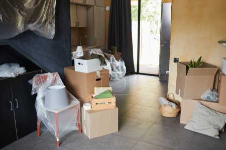 Photo for Background image of messy cardboard boxes in new home, family moving and relocation concept, copy space - Royalty Free Image