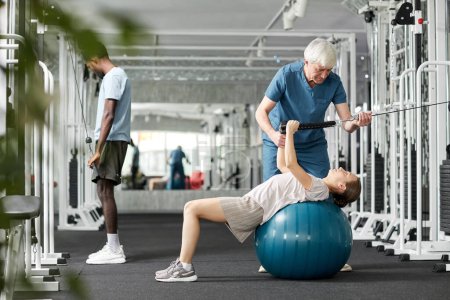 Photo for Portrait of senior rehabilitation therapist working with patients at gym in clinic, copy space - Royalty Free Image