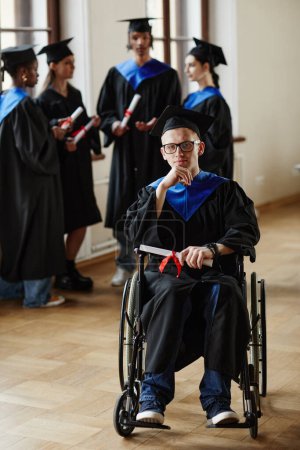 Foto de Retrato de cuerpo entero del joven con discapacidad en la ceremonia de graduación en la universidad - Imagen libre de derechos