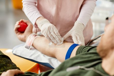 Photo for Close up of male donor giving blood at donation center with nurse helping, copy space - Royalty Free Image