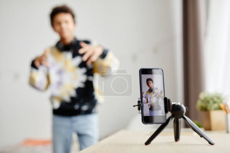 Photo for Background image of Gen Z teenager filming video for social media at home, focus on smartphone screen, copy space - Royalty Free Image