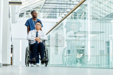 Photo for Full length portrait of smiling African American medic assisting man in wheelchair in modern clinic, copy space - Royalty Free Image