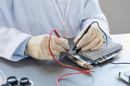 Photo for Close up of lab technician checking hardware parts at quality control station, copy space - Royalty Free Image