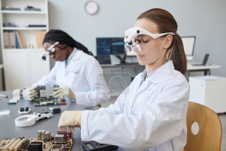 Photo for Portrait of two young female engineers working with electronic parts in laboratory, copy space - Royalty Free Image