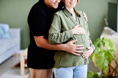 Téléchargez les photos : Plan recadré de couple lesbien heureux attendant bébé et embrassant avec amour avec les mains sur le ventre enceinte, espace de copie - en image libre de droit