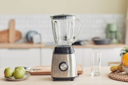 Background image of chrome blender on kitchen counter with fruits, copy space