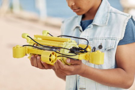 Photo for Cropped shot of young black boy holding yellow robot model, engineering for kids background - Royalty Free Image