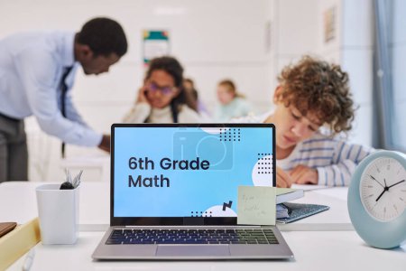 Photo for Background image of open laptop in school classroom with 6th Grade math screen, copy space - Royalty Free Image