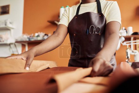 Photo for Close up of unrecognizable female artisan working with genuine leather in workshop, copy space - Royalty Free Image