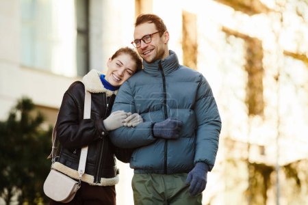 Photo for Happy young couple in warm clothing enjoying their walk in the city - Royalty Free Image