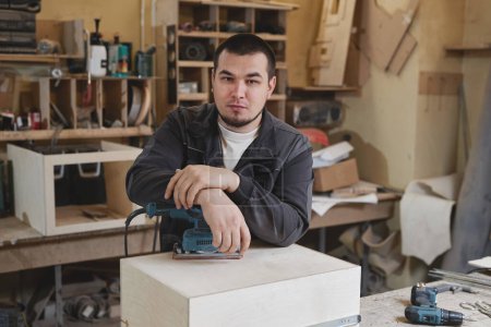 Photo for Portrait of confident male worker looking at camera while standing in woodworking workshop, copy space - Royalty Free Image