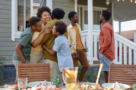 Photo for Portrait of happy black family embracing while enjoying Summer party outdoors, copy space - Royalty Free Image
